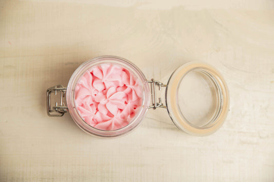 Open jar showing the whipped texture, with the labeled jar or lid visible nearby.